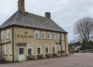 an old brick building with a sign on it at The Evenlode Rooms at Firehouse Oxford in Witney