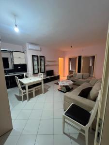 a living room with a couch and a table at Apartament Lola in Pogradec