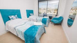 una camera da letto con due letti e una grande finestra di Villa Sapphire 62 a Castillo de Sabinillas Altre 43 foto