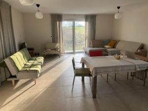 a living room with a table and a couch at Jelenec House in Jelenec