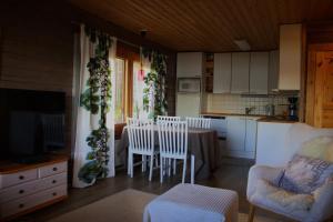 a kitchen and living room with a table and chairs at Private Villa At Lake 
