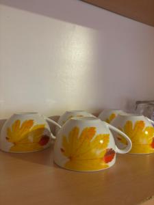four tea cups with leaves on them sitting on a table at Sunny Garden Old Town in Sarajevo +28 photos