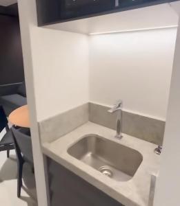 a sink in a small room with a table at Porto 2 Life Resort in Porto De Galinhas
