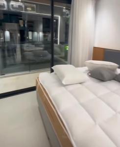 a bed with pillows on a train with a window at Porto 2 Life Resort in Porto De Galinhas +4 photos