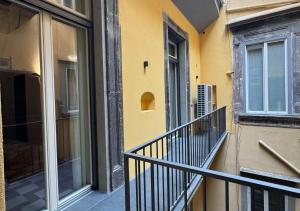 a yellow building with a balcony and a window at Dal Console Rooms in Naples