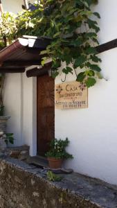 a door with a sign on the side of a building at Casa San Cristoforo Studio in Maggia