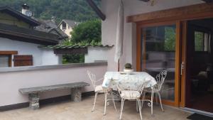 a table and chairs on a patio with a window at Casa San Cristoforo Studio in Maggia