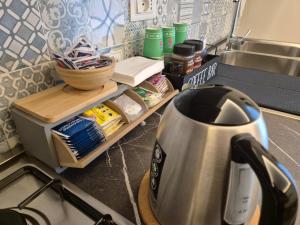 a tea kettle sitting on a counter next to a sink at Le Barchette B&B in Salerno +54 photos