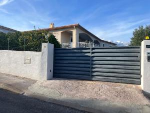 a gate in front of a house at Villa 47 in Biguglia +4 photos