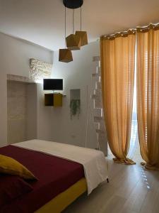 a bedroom with a bed in a room with curtains at B&B Iris in Terlizzi