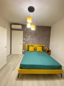 a bedroom with a large bed with yellow pillows at B&B Iris in Terlizzi