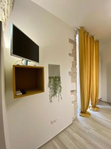 a living room with a flat screen tv on a wall at B&B Iris in Terlizzi