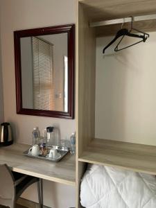 a bathroom with a sink and a mirror at The Hornbill Lodge in Nata +23 photos