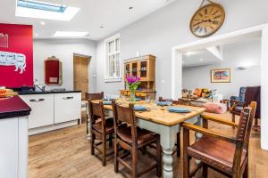 a kitchen and dining room with a table and chairs at Old School House in Burnham Market