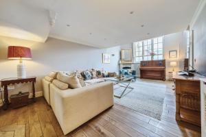 a living room with a couch and a table at Old School House in Burnham Market