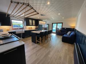 a kitchen and living room with a kitchen and a living room at Abalone Accommodation in Culbokie +29 photos