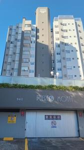 a building with a purple north sign in front of it at Apartamento para Sammer Fest 2026 in Blumenau