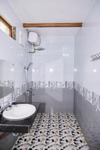 a white bathroom with a sink and a shower at Cosiana Homestay in Ninh Binh +46 photos