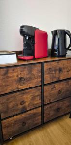 a dresser with a coffee maker on top of it at L'Ambre - Moderne - Equipé - Douche in Lourdes