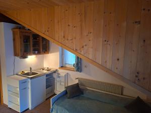 a small kitchen with a sink and a staircase at Gassermühle - Studio Appartments in Eggen