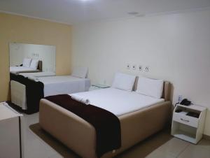 En eller flere senge i et værelse på Hotel Aliança