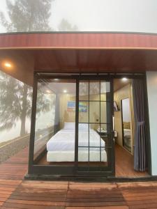 a room with a bed inside of a house at Kayana Capsul Dieng in Kejajar