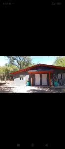 two pictures of a small house with aicter at Don Andrés y doña cuca in Merlo