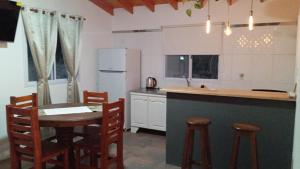 a kitchen with a table and chairs in a kitchen at Don Andrés y doña cuca in Merlo +8 photos