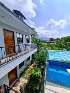 a view from the balcony of a house with a swimming pool at Bleu Saphire Apartments in Los Baños