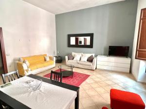 a living room with a couch and a table at Sardinian Gallery Corso in Bosa