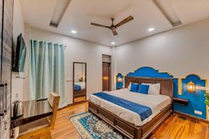 a bedroom with a bed and a ceiling fan at Subah E Banaras in Varanasi