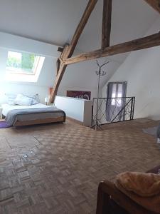 a attic bedroom with a bed and a window at Loft Spa Prestige in Villampuy +8 photos