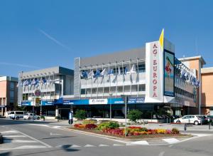 a building with a sign in front of a street at Appartamenti Atlante in Bibione +11 photos