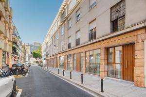 an empty street in a city with buildings at Arroyo 3 Apartments in Seville