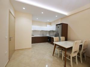 a kitchen and dining room with a table and chairs at Azure Dream Apartment in Durrës