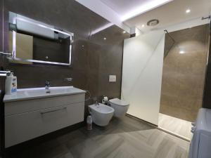 a bathroom with a sink and a toilet at Azure Dream Apartment in Durrës