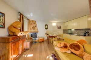 a living room with a large teddy bear sitting on a couch at Genziana in Pré-Saint-Didier