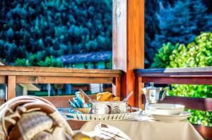 a table with a plate of food on a porch at Genziana in Pré-Saint-Didier