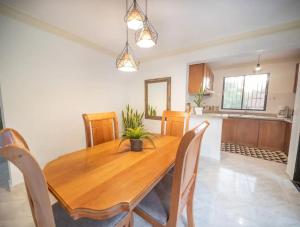 a dining room with a wooden table and chairs at Fully Equipped 2br Apt-dt5mins To The Beach in Sosúa