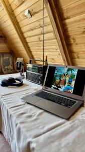 un ordenador portátil sentado en la parte superior de una cama en Old farm 1, en Ijevan 9 fotos más