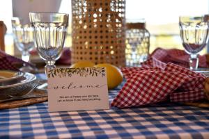 a table with a blue and red checkered table cloth with a welcome sign at Philippos 1 in Diaporos