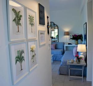 a living room with pictures of palm trees on the wall at Philippos 1 in Diaporos