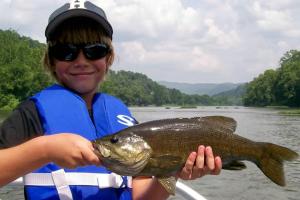 a man holding a large fish in his hand at King Suite for a Cozy Romantic Getaway Overlooking the New River in Independence, Virginia in Independence