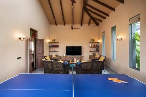 a living room with a ping pong table at SaffronStays Maitri in Igatpuri