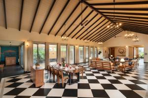 a dining room with a checkered floor at SaffronStays Maitri in Igatpuri