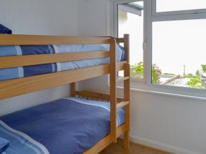 a bunk bed in a room with a window at Breakwater View in Turnchapel