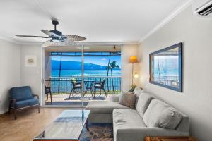 a living room with a couch and a view of the ocean at Maalaea Kai 311 - Direct Ocean Front, Split AC in Wailuku