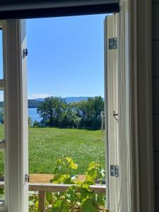 an open window with a view of a field at Lovely tiny house with a dream view ! 