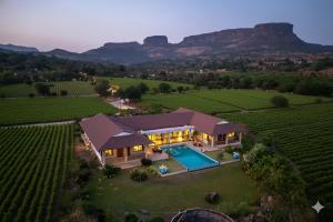 an aerial view of a house with a swimming pool at SaffronStays Maitri in Igatpuri