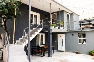 a staircase leading up to a house with a table at 3 Min To Center Stylish Stay's in Tirana